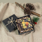Gift box with decorative items on a textured surface