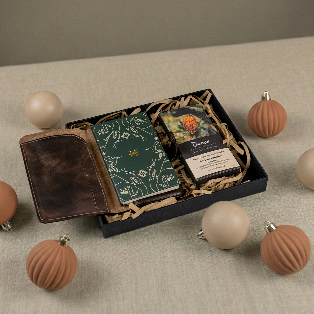 Set of festive gift box with items including a ecuadorian design booklet, leather cover, and durca chocolate grand cru box.
