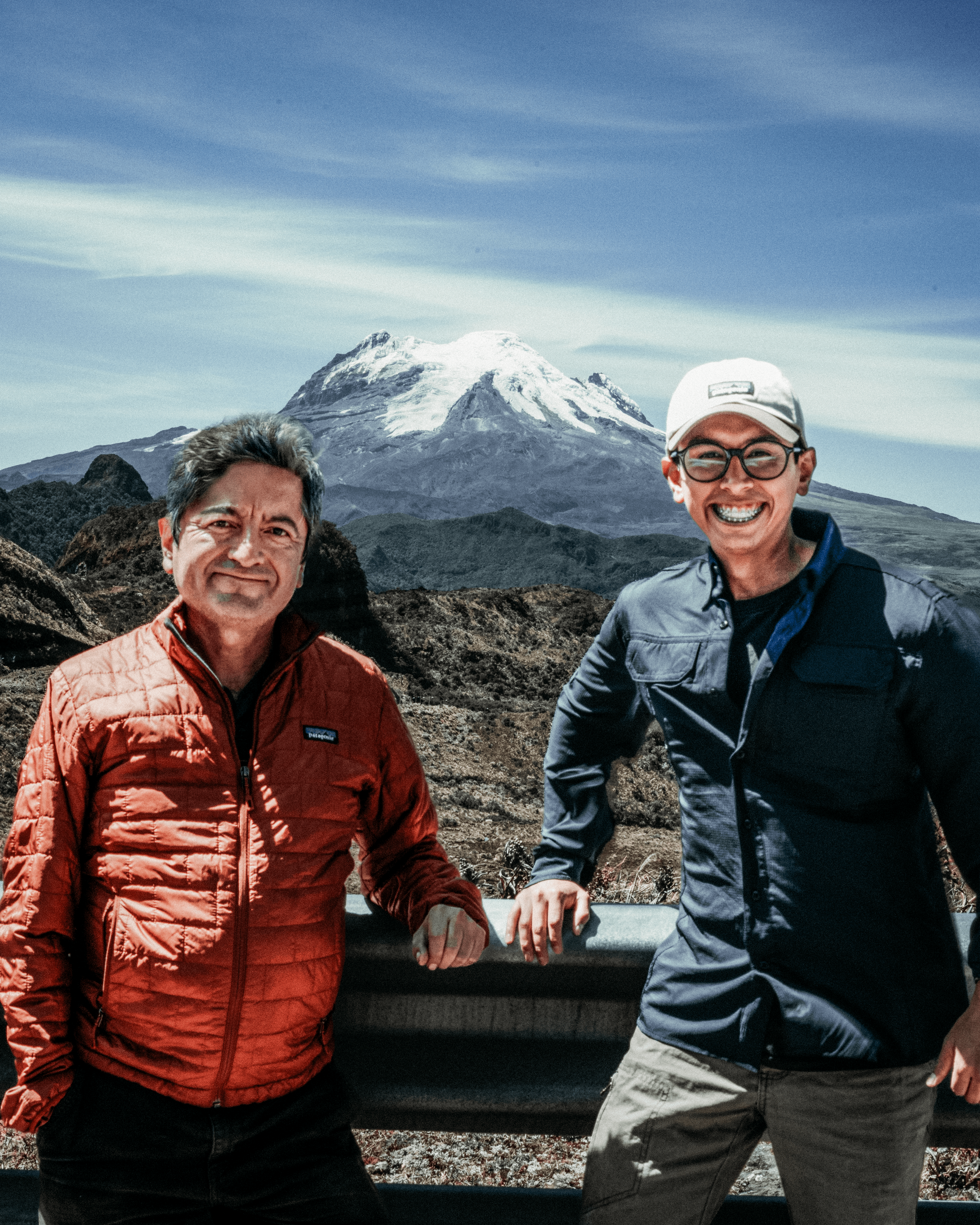 David and José Durán, founders of Durca Dark Chocolate, standing together before a snowy Ecuadorian volcano, symbolizing the origin and grandeur that inspire their craft.
